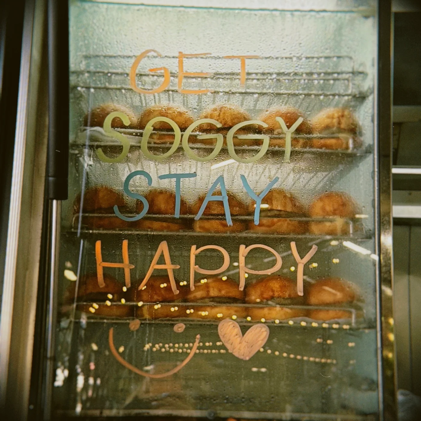 Get soggy, stay happy, handwritten on the burger steamer at SOSMOS